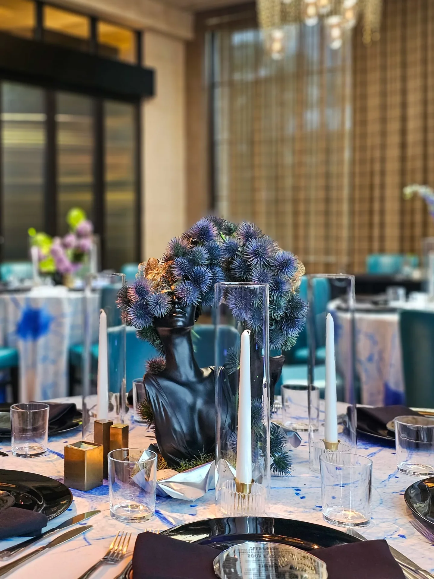 Candlelit corporate dinner table with florals by EVENT by OVA